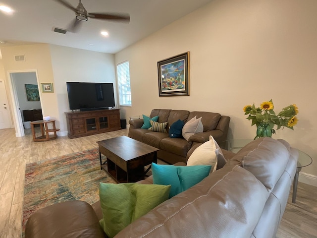 living room featuring ceiling fan and light hardwood / wood-style floors