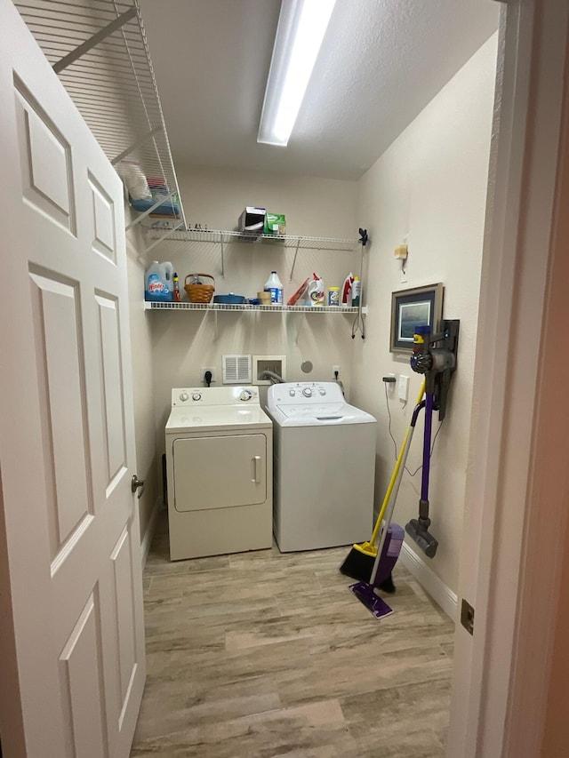 washroom featuring light hardwood / wood-style floors and independent washer and dryer