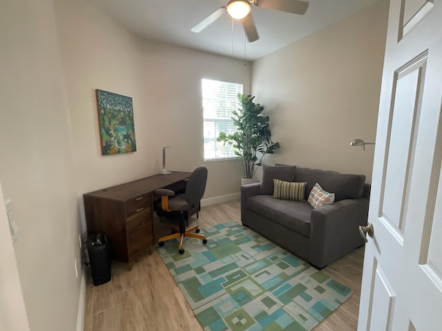 home office with ceiling fan and light hardwood / wood-style flooring