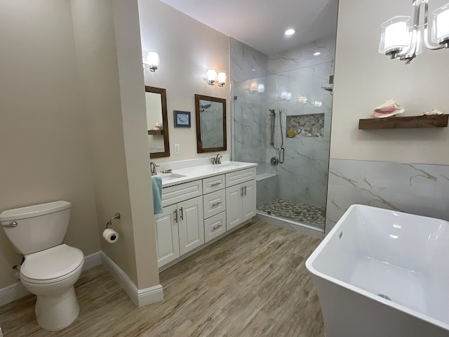 full bathroom featuring vanity, separate shower and tub, wood-type flooring, a notable chandelier, and toilet