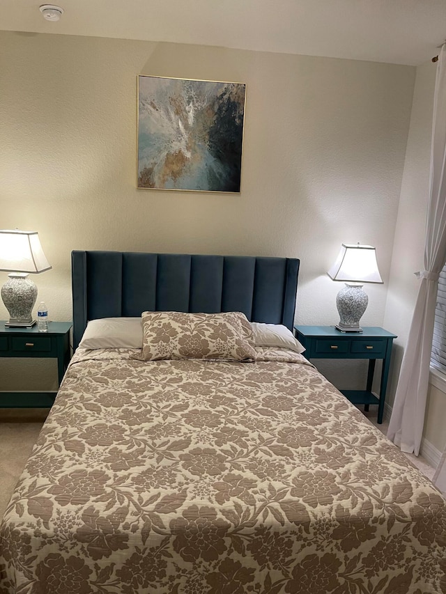 bedroom featuring light colored carpet