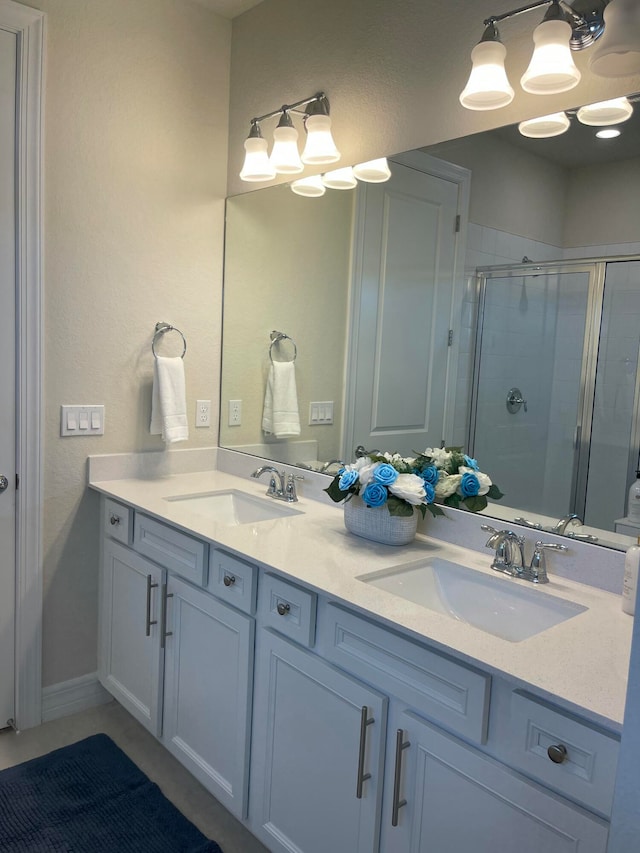 bathroom with vanity and a shower with door