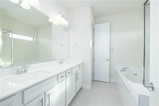 bathroom with vanity and a relaxing tiled tub