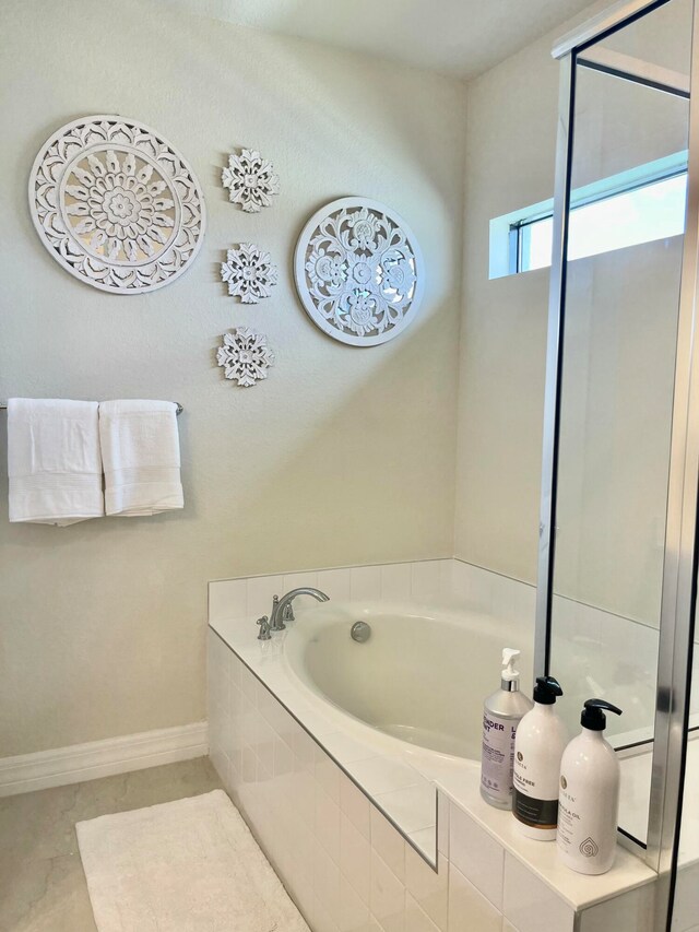 bathroom with a relaxing tiled tub