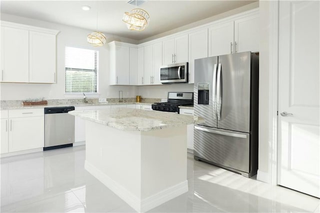 kitchen with hanging light fixtures, a center island, white cabinets, and stainless steel appliances