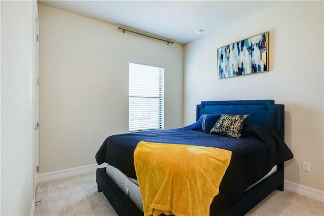 bedroom featuring light carpet