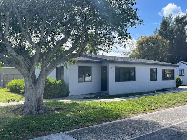 ranch-style home with a front lawn