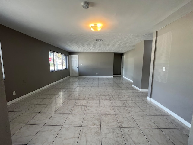 spare room with a textured ceiling