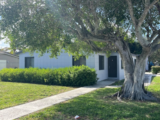 obstructed view of property with a front yard