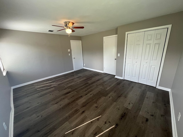 unfurnished bedroom with ceiling fan and dark hardwood / wood-style flooring