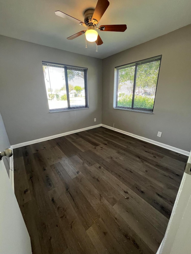 unfurnished room with dark hardwood / wood-style floors and ceiling fan