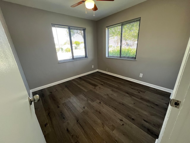 unfurnished room featuring dark hardwood / wood-style flooring and ceiling fan