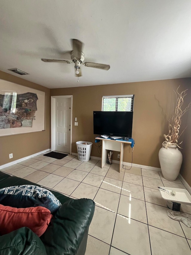 tiled living room with ceiling fan