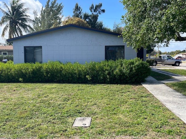 view of property exterior with a yard