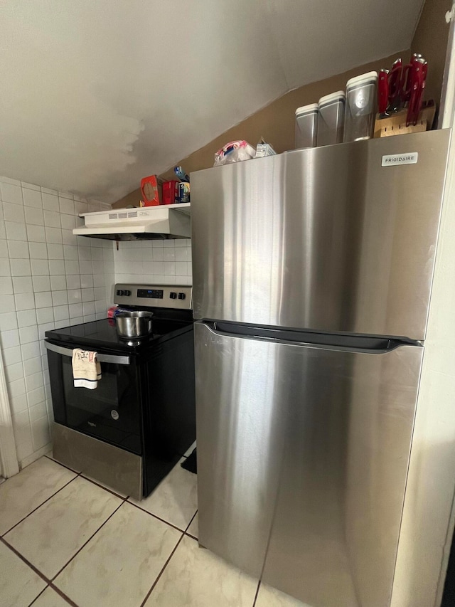 kitchen featuring lofted ceiling, extractor fan, tile walls, and appliances with stainless steel finishes