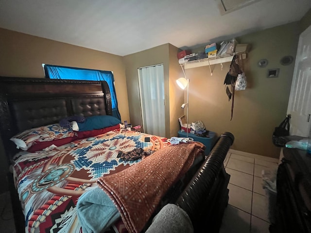 bedroom featuring tile patterned floors and a closet