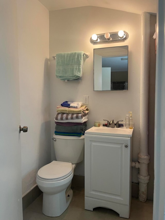 bathroom featuring tile patterned floors, vanity, and toilet