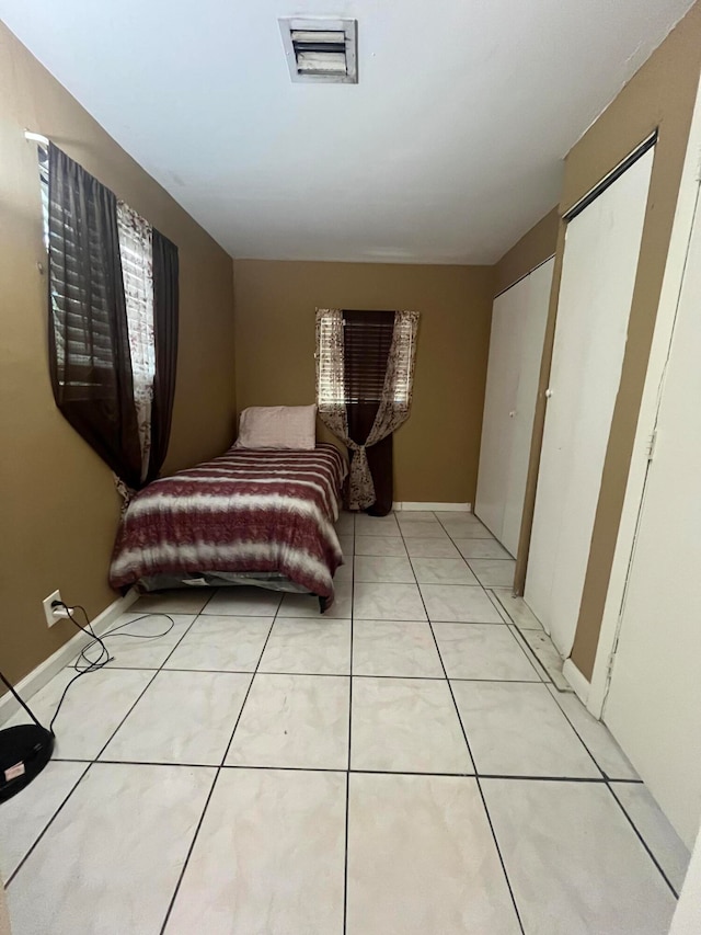 bedroom featuring light tile patterned floors