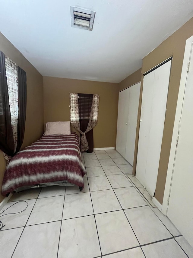 bedroom featuring light tile patterned flooring