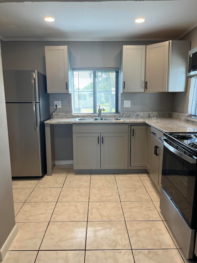 kitchen featuring light stone countertops, stainless steel appliances, light tile patterned flooring, and sink