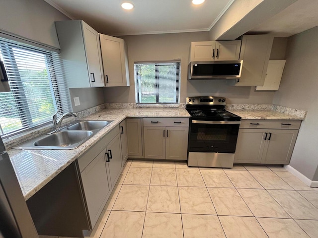 kitchen featuring appliances with stainless steel finishes, gray cabinetry, crown molding, sink, and light tile patterned flooring