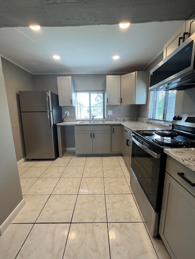 kitchen featuring gray cabinetry, sink, crown molding, light stone countertops, and appliances with stainless steel finishes