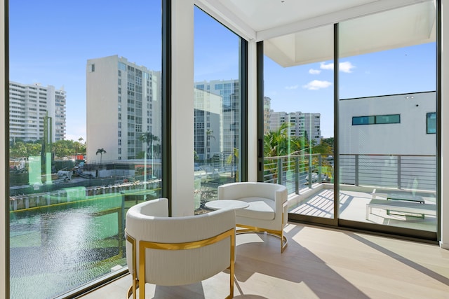 sunroom featuring a healthy amount of sunlight and a water view