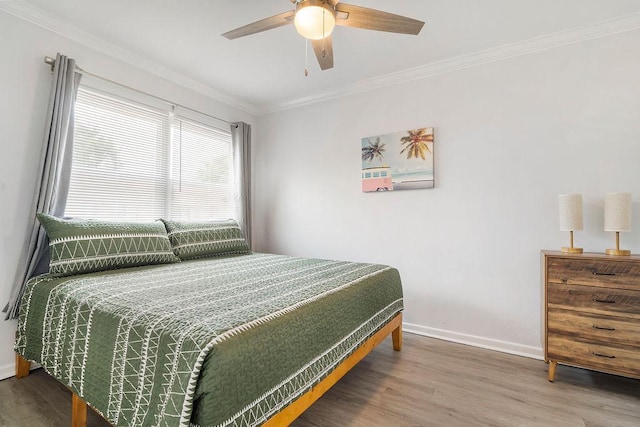 bedroom with crown molding, wood-type flooring, and ceiling fan