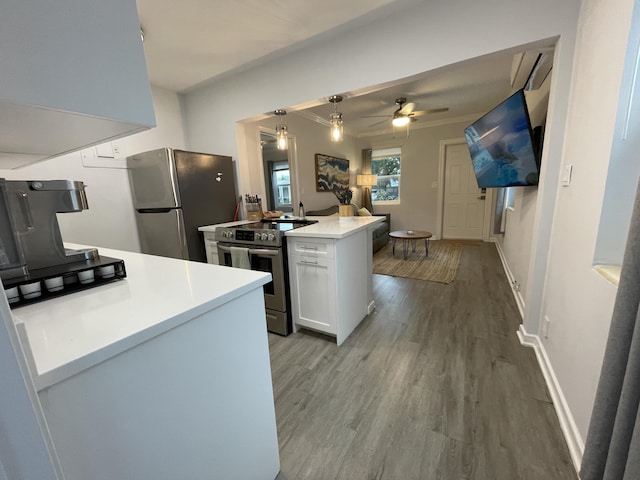 kitchen with crown molding, ceiling fan, white cabinetry, stainless steel appliances, and light wood-type flooring