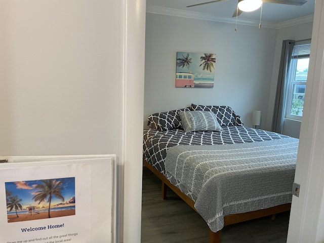 bedroom with crown molding, ceiling fan, and hardwood / wood-style flooring