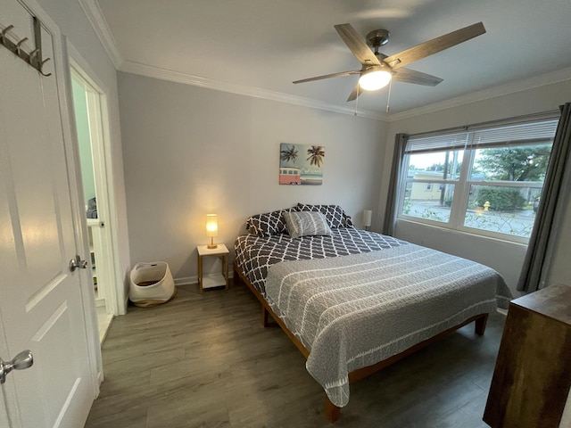 bedroom with ornamental molding, dark hardwood / wood-style flooring, and ceiling fan