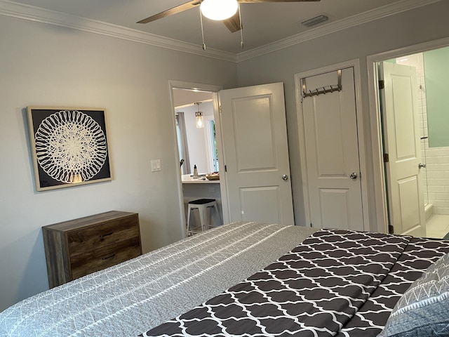 bedroom featuring ceiling fan, ensuite bath, and ornamental molding