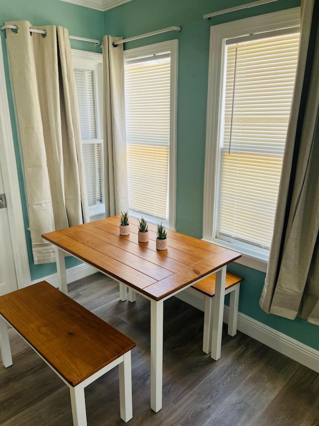 dining space with dark wood-type flooring, crown molding, and breakfast area