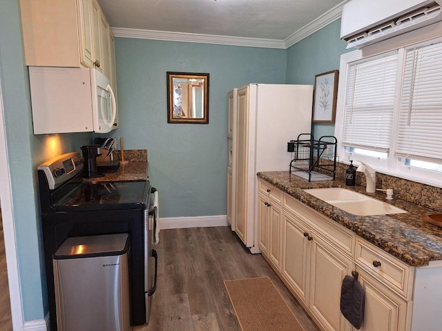 kitchen featuring sink, a wall mounted AC, dark stone countertops, dark hardwood / wood-style flooring, and white appliances