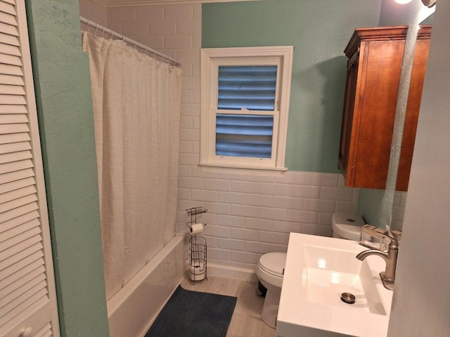 full bathroom with vanity, tile walls, shower / bath combination with curtain, and toilet