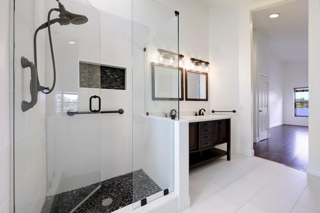 bathroom with hardwood / wood-style floors, vanity, and an enclosed shower