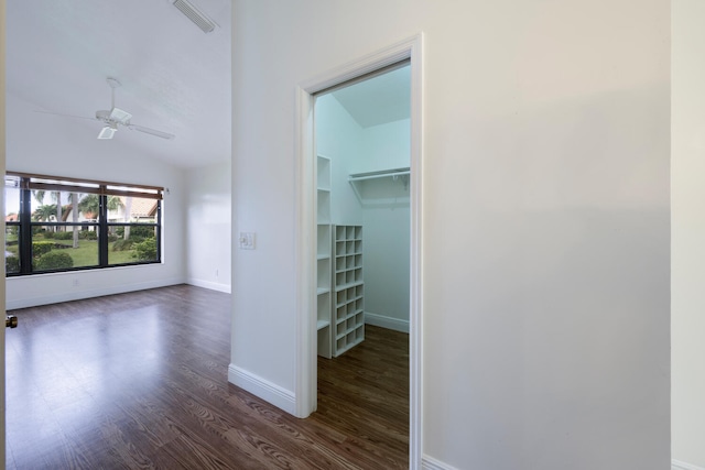 interior space featuring dark wood-type flooring and vaulted ceiling