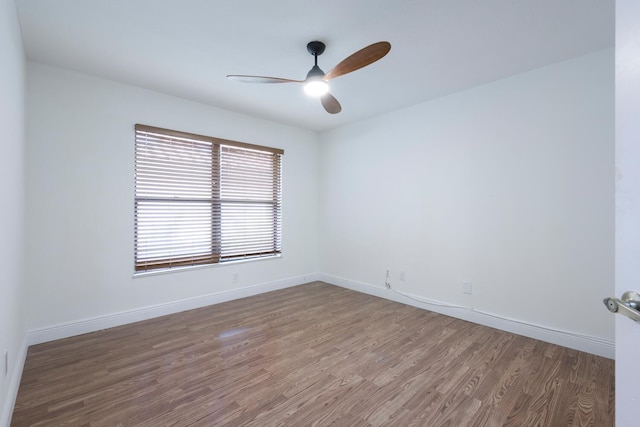 empty room with ceiling fan and hardwood / wood-style floors