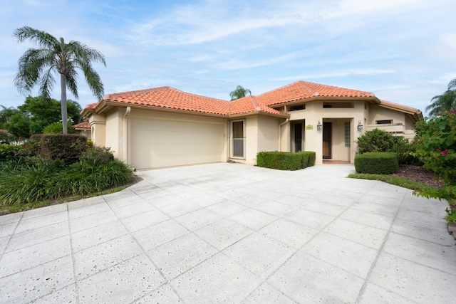 mediterranean / spanish home with a garage