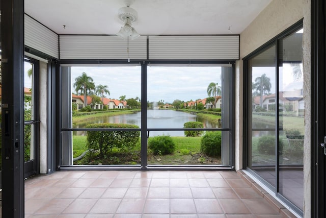 2843 SW Mariposa Cir, Palm City, FL 34990 - unfurnished sunroom featuring a water view and tile patterned flooring
