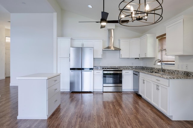 2843 SW Mariposa Cir, Palm City, FL 34990 - kitchen featuring stainless steel appliances, a sink, wall chimney range hood, white cabinets, and high vaulted ceiling