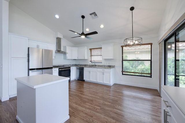 2843 SW Mariposa Cir, Palm City, FL 34990 - kitchen with appliances with stainless steel finishes, wall chimney range hood, light countertops, white cabinets, and ceiling fan