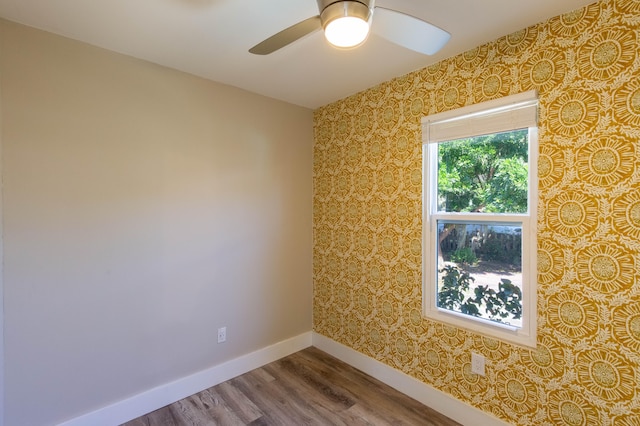 spare room with hardwood / wood-style floors and ceiling fan