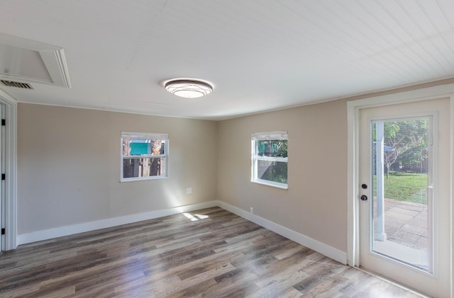 unfurnished room featuring wood-type flooring and plenty of natural light