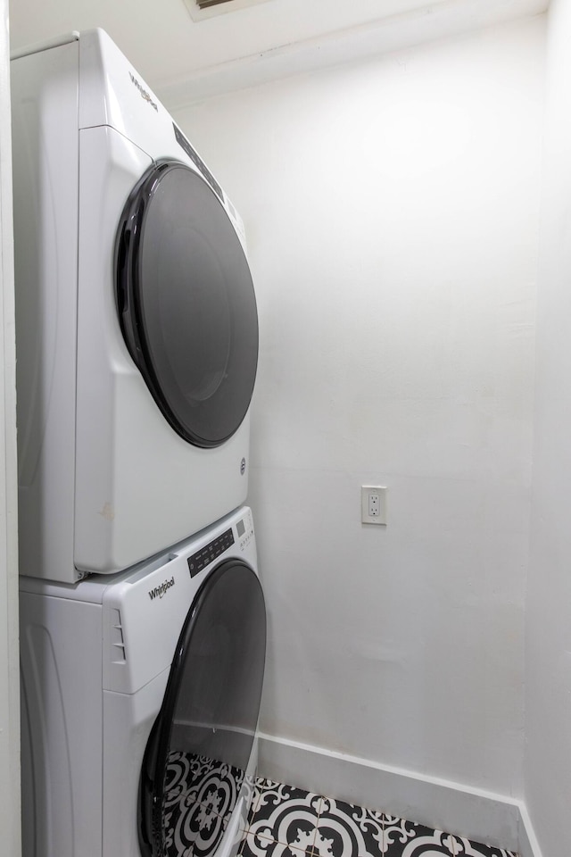 laundry area featuring stacked washer and dryer