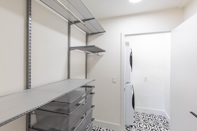 walk in closet featuring stacked washer / dryer