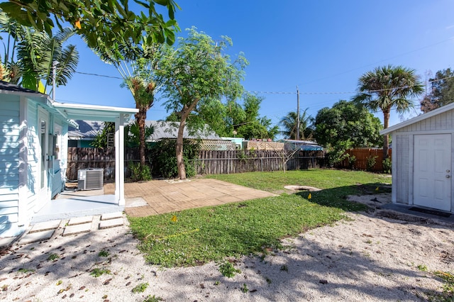 view of yard featuring central air condition unit and a patio area