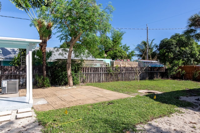 view of yard featuring a patio and central AC