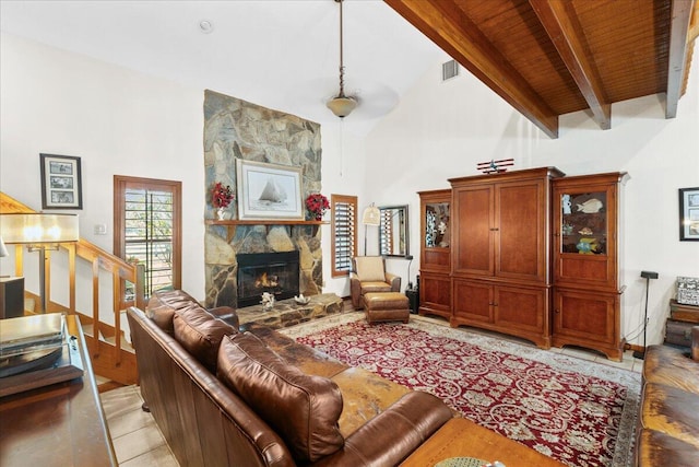 living room with a fireplace, wooden ceiling, high vaulted ceiling, and beamed ceiling