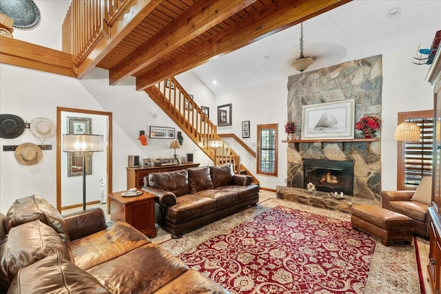 living room with beam ceiling, wooden ceiling, a fireplace, and a wealth of natural light